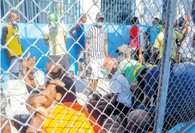  ?? AP ?? Inmates gather inside the National Penitentia­ry in downtown Port-au-Prince, Haiti, on Sunday, March 3.