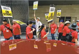  ?? Luis Sinco Los Angeles Times ?? HOTEL workers picket outside the JW Marriott at L.A. Live in July. The hotel is one of 10 that reached tentative deals with Unite Here Local 11 in recent days.