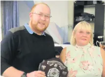  ??  ?? 180 9-Dart Throw-off Winner Dean Maxwell being presented with his trophy by Trophy sponsor and LDPCDL committee member Julia Want .