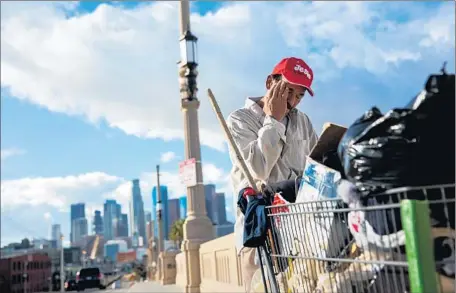  ?? Marcus Yam Los Angeles Times ?? REYNALDO “RAY” GONZALEZ,
homeless for five years, walks back to his encampment on the 1st Street Bridge in Los Angeles.