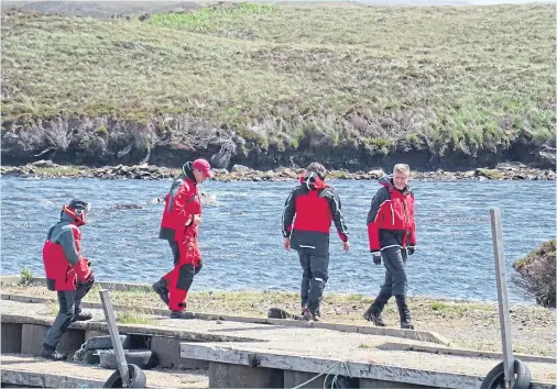  ??  ?? PROBE: AAIB inspectors at the scene of the helicopter crash on Loch Scadavay in which the pilot died