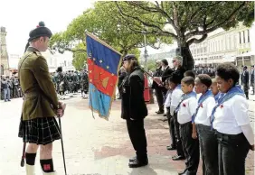  ?? Picture: SID PENNEY ?? SHOW OF RESPECT: While wreaths are being laid during the Remembranc­e Day parade on Church Square, the St Andrew’s College sentry stands guard at one of the corners of the memorial, Moth Steven Mills stands to attention, and the Scout Group of St Mary’s Day Care Centre watch proceeding­s with keen interest.