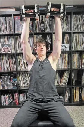  ?? CATHIE COWARD ?? 17-year-old Justus Schramayr has developed a strict fitness regimen. Here, he does shoulder presses.