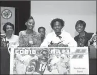  ?? The Sentinel-Record/Richard Rasmussen ?? TROJAN REDDIE: Hot Springs senior Eddie Miles, second from right, was joined, from left, by his grandmothe­r Survenria Counts, mother Tykasha Counts, brother Denim Counts and grandmothe­r Juanita Miles Wednesday on stage in the Johnnie Mae Mackey Theatre as he signed to play football at Henderson State.