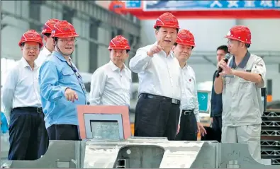  ?? XIE HUANCHI / XINHUA ?? President Xi Jinping inspects Alnan Aluminium Co in Nanning, capital of the Guangxi Zhuang autonomous region, on Thursday. The president called for building a strong real economy and boosting the manufactur­ing industry.