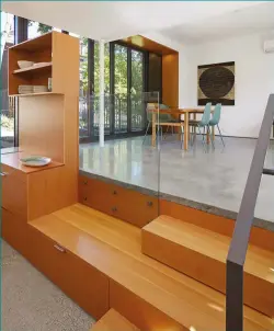  ??  ?? Kent Aggus of Built Work designed the Douglas fir kitchen, including the middle stair that extends across to a room-dividing unit, and acts as a bench containing storage.