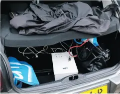  ?? DUTCH DEFENSE MINISTRY VIA AP ?? A photograph released by the Dutch Ministry of Defence shows a rental vehicle’s trunk loaded with a computer, battery and a white transforme­r.
