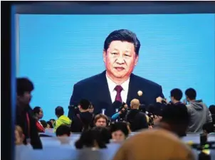  ?? AFP ?? Chinese President Xi Jinping is seen on a big screen at an expo in Shanghai on Monday.