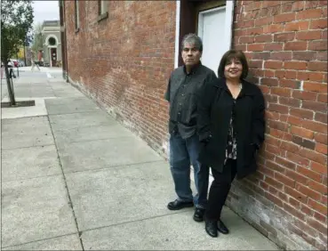  ?? ANDREW SELSKY — THE ASSOCIATED PRESS ?? Delmiro Trevino and his wife Oralia pose in front of a building in Independen­ce, Ore., where the Hi-Ho restaurant used to be located. It was in that restaurant, in 1977, that Delmiro Trevino was in when three sheriff’s deputies and a policewoma­n came in and demanded he show documents proving he was American. The racial profiling of Trevino, an American born in Texas, led to Oregon becoming America’s first sanctuary state. Now, Oregonians are deciding in the Nov. 6 election whether to repeal the law, even as some other states, like Vermont, have adopted sanctuary policies and others, like Texas, have banned towns from adopting them.