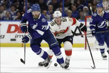  ?? CHRIS O’MEARA- THE ASSOCIATED PRESS ?? Tampa Bay Lightning defenseman Victor Hedman (77) moves the puck in front of Florida Panthers center Noel Acciari (55) during the first period of a game Monday, Dec. 23, 2019, in Tampa, Fla.