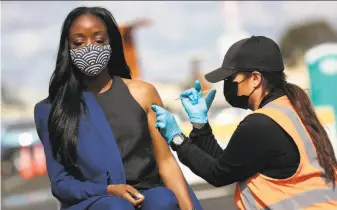  ?? Santiago Mejia / The Chronicle ?? Dr. Nadine Burke Harris, California’s surgeon general, receives the Johnson & Johnson vaccine at the Oakland Coliseum. Harris says her mother also got the oneshot vaccine this week.