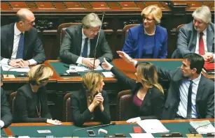  ?? (Alessandro Bianchi/Reuters) ?? NEWLY APPOINTED Italian Prime Minister Paolo Gentiloni (second from left) is congratula­ted by his ministers at the end of a speech before a confidence vote yesterday at the parliament in Rome.