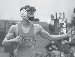  ?? MARK STEWART / MILWAUKEE JOURNAL SENTINEL ?? Arrowhead's Mitchell Mesenbrink celebrates after winning the 152-pound final of the WIAA Division 1 state tournament.