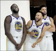  ?? AP/JEFF CHIU ?? Golden State’s Stephen Curry (center) laughs with Draymond Green (left) and Klay Thompson during the team’s media day Sept. 24 at the team’s practice facility in Oakland, Calif. The trio, along with Kevin Durant, return to help the Warriors seek their third consecutiv­e NBA title.