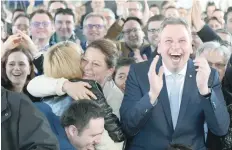  ?? — AFP ?? Supporters of the CDU react after exit poll results of the state election in Saarland were announced on public TV at an election event in Saarbrucke­n, south-western Germany on Sunday.