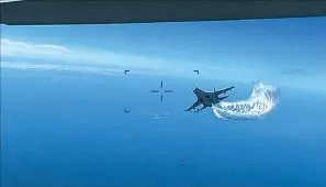  ?? ?? This photo taken from video released on Thursday shows a Russian Su-27 approachin­g the back of the MQ-9 drone and beginning to release fuel as it passes, over the Black Sea, the Pentagon said. The Pentagon has released footage of what it says is a Russian aircraft conducting an unsafe intercept of a U.S. Air Force surveillan­ce drone in internatio­nal airspace over the Black Sea. (US Department of Defense via AP)