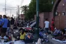  ?? Photograph: Paul Ratje/Reuters ?? Migrants camp out in front of the Sacred Heart church in advance of the planned 11 May end of Title 42 regulation­s.