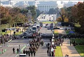  ?? SARAH SILBIGER / AP ?? Troops march during a full honors procession honoring the centennial anniversar­y of the Tomb of the Unknown Soldier on Thursday at Arlington National Cemetery in Arlington, Va. The Lincoln Memorial in Washington is shown in the distance.