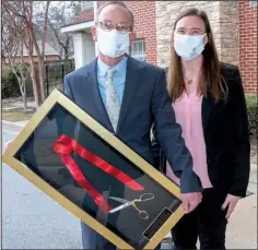  ??  ?? Dr. Whit Hall prepares to cut through a ribbon held by Emily Paul and Kristi Moody.
Ronnie Fehrenbach with Nicole Winters