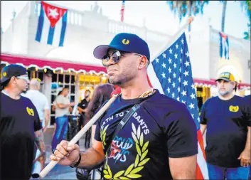  ?? Eva Maria Uzcategui
Tribune News Service ?? Henry “Enrique” Tarrio, Proud Boys leader, holds a U.S. flag July 16, 2021, during a protest in Miami showing support for Cubans demonstrat­ing against their government.