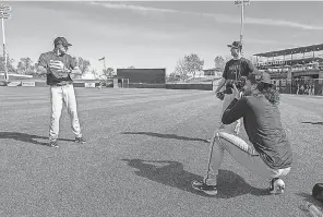  ?? MORRY GASH/ AP ?? Giants teammate Sean Manaea takes pictures of Taylor Rogers, at left, and Tyler Rogers during a spring training workout Saturday.