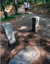  ??  ?? A stone inscriptio­n marks the actual site of Henry David Thoreau's cabin on the shores of Walden Pond in Concord, Mass.