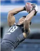  ?? MICHAEL CONROY/AP ?? Auburn defensive back Noah Igbinoghen­e runs a drill at the scouting combine March 1. He was drafted Thursday by the Dolphins.