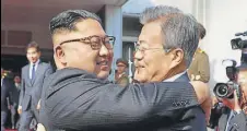  ?? AP ?? Kim Jong Un (L) hugs Moon Jaein after a meeting on Saturday.