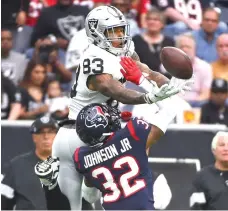  ?? Eric Christian Smith/ Associated Press ?? ■ Houston Texans cornerback Lonnie Johnson (32) breaks up a pass intended for Oakland Raiders tight end Darren Waller (83) on Sunday in Houston.