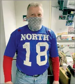  ?? PHOTO PROVIDED ?? On high school jersey day at PHS, Gene Skirvin rocked his high school football All Star gersey from the North All Stars. In the back of the photo is a white board filled with photos and momentos of past students, including a “hey trouble” coconut — the collection is one Skirvin is most proud of as teacher of 40 years.