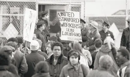  ?? Gary Fong / The Chronicle 1984 ?? Pickets show solidarity during a longshore strike at Pier 80 in San Francisco in December 1984.