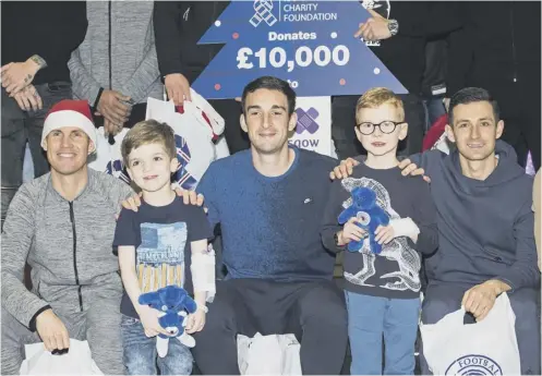  ??  ?? 0 Rangers players, from left, Kenny Miller, Lee Wallace and Jason Holt met six-year-old Bryce Barron from Stornoway and James Lumsden, aged 5 from Newton Mearns, when the Ibrox squad visited the Royal Hospital for Children in Glasgow yesterday.