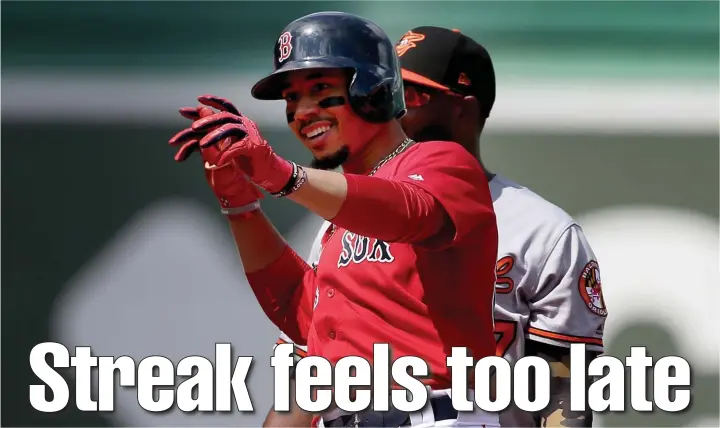  ?? NANCY LANE / BOSTON HERALD ?? ALL SMILES: Mookie Betts signals to the dugout after hitting a double in the third inning of the Red Sox’ 13-7 win against the Baltimore Orioles yesterday at Fenway Park.