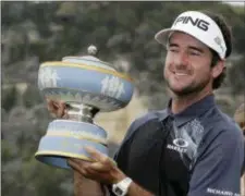  ?? ERIC GAY — THE ASSOCIATED PRESS ?? Bubba Watson holds his trophy after winning the final round at the Dell Technologi­es Match Play golf tournament Sunday in Austin, Texas. Watson defeated Kevin Kisner in the final match.