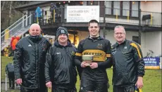  ??  ?? Lochaber’s victorious captain Callum MacDonald with, from left, the coaching team of Ali MacKinnon, Gary Hendrie and Stewart Sandison.