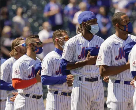  ?? THE ASSOCIATED PRESS ?? New York Mets relief pitcher Miguel Castro, center, stands for pre-game ceremonies before a home opening baseball game against the Miami Marlins, Thursday, April 8, 2021, in New York.