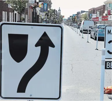  ?? CLIFFORD SKARSTEDT EXAMINER ?? New traffic barricades are set up along George Street between Murray and Sherbrooke streets reduced to one lane southbound for vehicular traffic on Saturday. The changes are temporary as part of the measures being put in place during the COVID-19 pandemic.