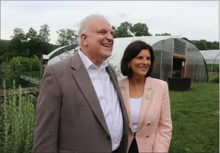  ?? JEN SAMUEL — MEDIANEWS GROUP ?? Retired state Sen. Andrew Dinniman smiles alongside Chester County Commission­er Marian Moskowitz during a dedication event for the Senator Andrew Dinniman Garden at Springton Manor Farm in Chester County.