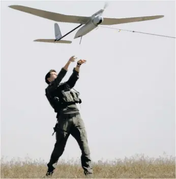  ?? ?? An Israeli soldier lifts a drone near the border of the Gaza Strip and southern Israel on
15 April. Israel’s allies have urged the country to avoid escalation of conflict with Iran after it launched hundreds of missiles and drones at Israel. Photo: Amir Levy/getty Images