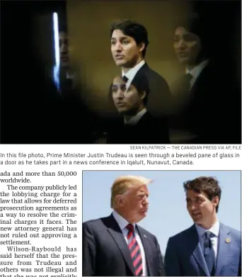  ?? SEAN KILPATRICK — THE CANADIAN PRESS VIA AP, FILE ?? In this file photo, Prime Minister Justin Trudeau is seen through a beveled pane of glass in a door as he takes part in a news conference in Iqaluit, Nunavut, Canada.