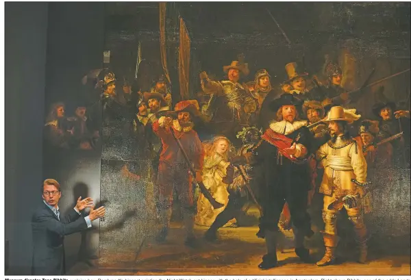  ?? (AP/Peter Dejong) ?? Museum director Taco Dibbits explains how Rembrandt’s biggest painting the Night Watch got bigger with the help of artificial intelligen­ce in Amsterdam. Right above Dibbits, one of the added parts is seen.