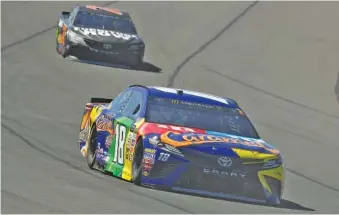  ?? THE ASSOCIATED PRESS ?? Kyle Busch leads Martin Truex Jr. into the first turn at Pocono Raceway during Sunday’s race in Long Pond, Pa. Busch had gone 36 NASCAR Cup Series points races without a victory before finishing first Sunday.