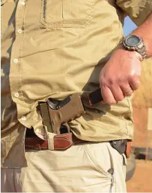 ??  ?? LEFT: Use your belt to hold the handgun while reloading.
RIGHT: You can use your belt, holster or in this case a mag pouch, to rack the slide.