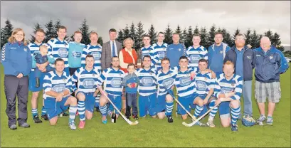  ?? Photo: Neil Paterson ?? The victorious Newtonmore team celebrate winning the Sir Tommy MacPherson Memorial Trophy after defeating Kingussie 4-1 at the Dell last Friday.