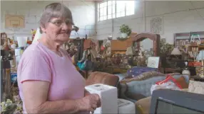  ?? Melody Dareing/ SJ ?? Edna Bowen stands with her gym full of items for customers to see.