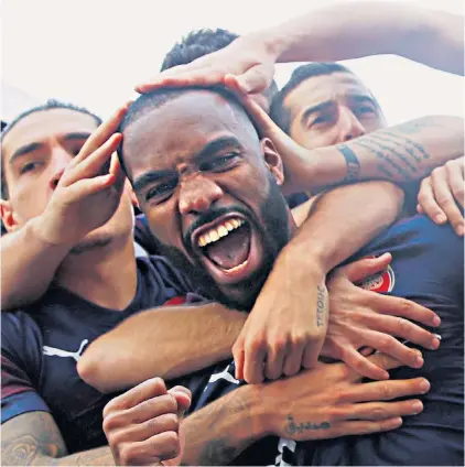  ??  ?? Coming good: Alexandre Lacazette celebrates his second goal in Arsenal’s rout of Fulham. The French striker has scored five times in his past seven games