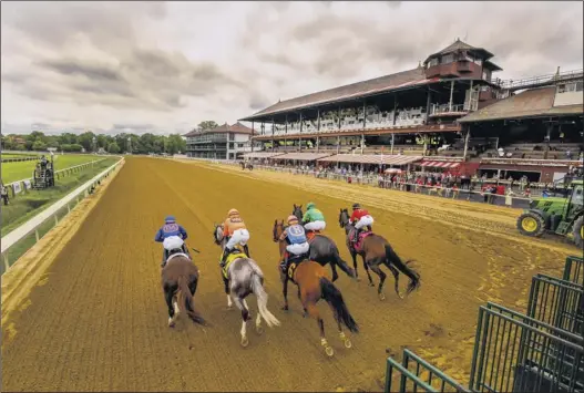  ?? Skip Dickstein / Special to the Times Union ?? The view at Saratoga Race Course had to look odd even to the horses as they took off for the first race of the meet on Thursday. Save for a few people who work with the horses and other essential personnel, the grandstand­s at the venerable track were empty.