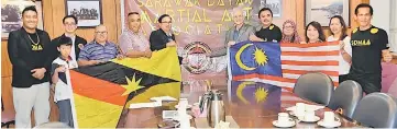  ??  ?? Abdul Wahab (sixth right ), Dom (sixth left) and others hold the state and national flags in a photo-call.