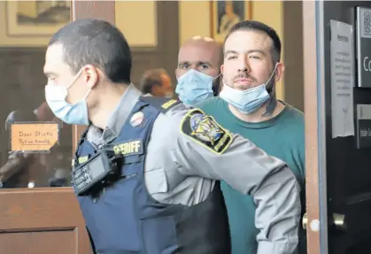  ?? TIM KROCHAK ■ THE CHRONICLE HERALD ?? Adam Joseph Drake is led out of Halifax provincial court Oct. 31, 2022, after being arraigned on a charge of first-degree murder in the November 2016 shooting death of Tyler Keizer. Drake, 32, is also charged with first-degree murder in the September 2022 stabbing death of Dartmouth rap artist Pat Stay.