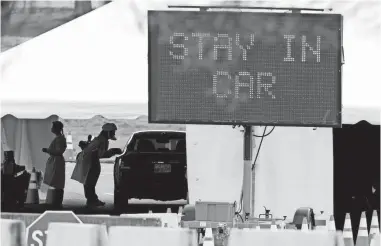  ?? MAX GERSH/USA TODAY NETWORK ?? A car goes through the COVID-19 drive-through testing facility March 23 at the Memphis fairground­s. Though people with preexistin­g conditions are at higher risk, many survive.